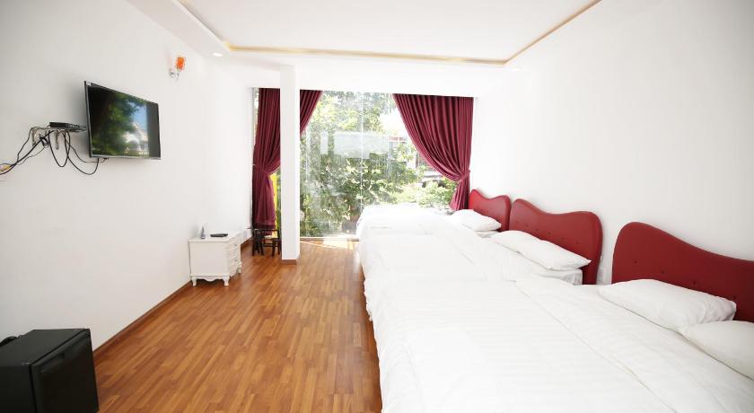 a hotel room with a bed and a television, Hotel ABC in Quy Nhon (Binh Dinh)