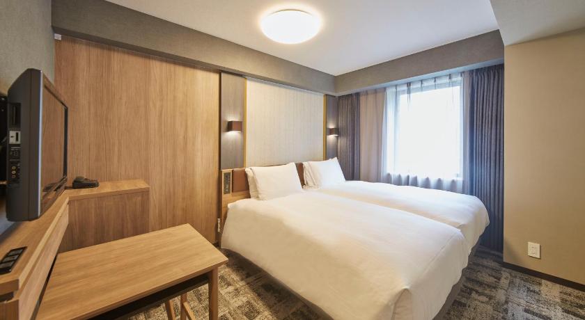 a hotel room with a bed and a desk, Richmond Hotel Narita in Narita