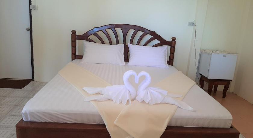 a bed with a white blanket and pillows on top of it, Cameron Island Resort in Trang