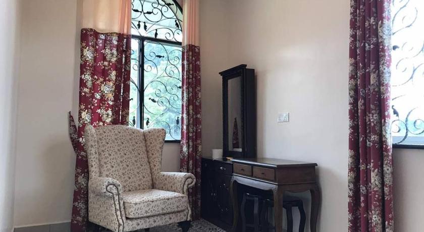 a living room filled with furniture and a window, Golden Hill in Cameron Highlands
