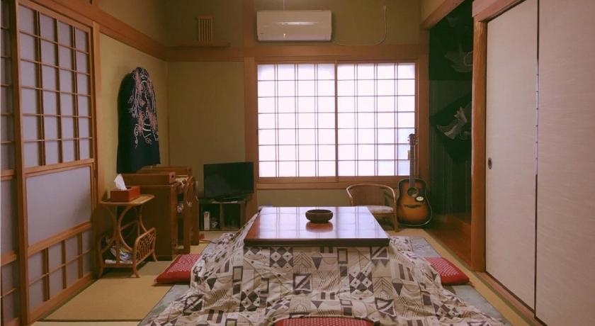a living room filled with furniture and a window, MaruHouse in Nachikatsuura