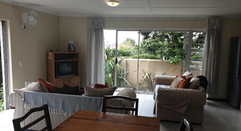 a living room filled with furniture and a tv, Amakaya Backpackers Travellers Accommodation in Plettenberg Bay