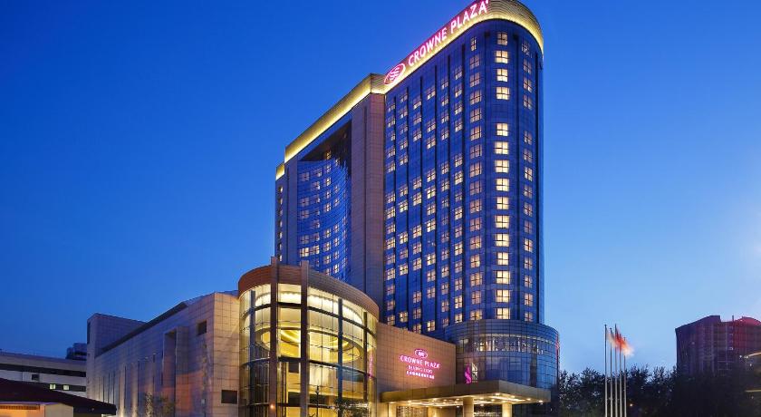 a large building with a clock on the front of it, Crowne Plaza Beijing Lido in Beijing