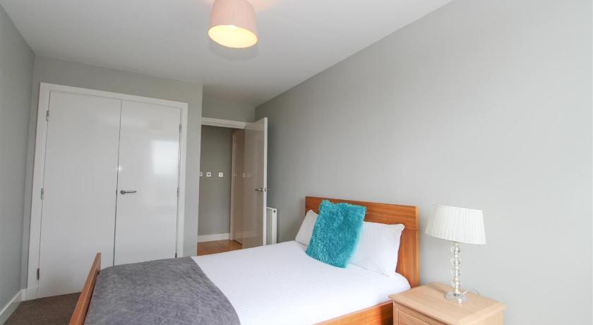 a bedroom with a bed and a lamp, Dreamhouse Apartments Glasgow City Centre in Glasgow