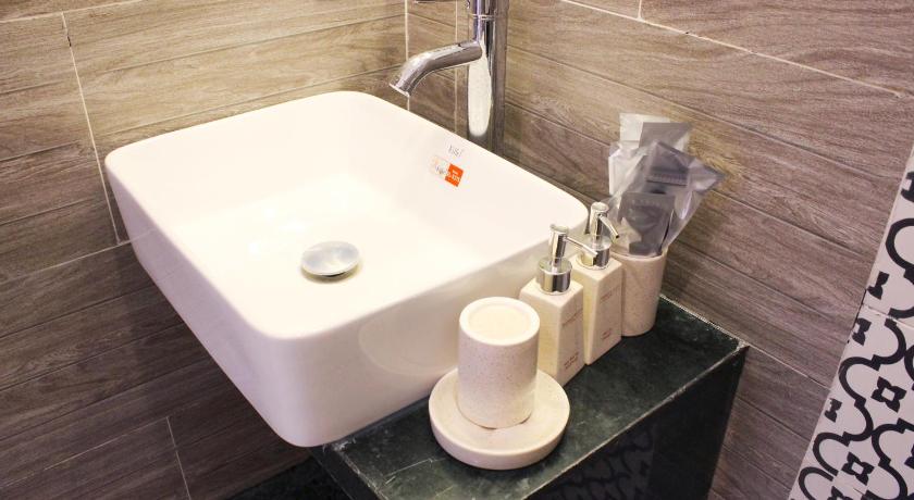 a bathroom sink with a soap dispenser next to it, EMERALD OCEAN HOTEL in Phan Thiet