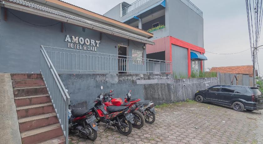 a red motorcycle parked in front of a brick building, Amoory Venice in Bandung