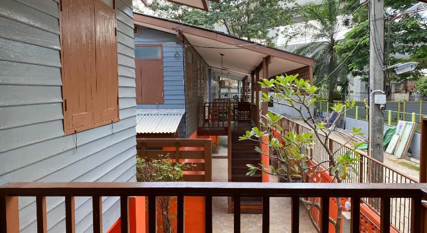 a patio area with a patio door and a balcony, Bed In Beyt boutique hotel in Nonthaburi