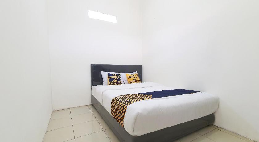 a bedroom with a white bed and white walls, SPOT ON 2726 Kopo 355 in Bandung