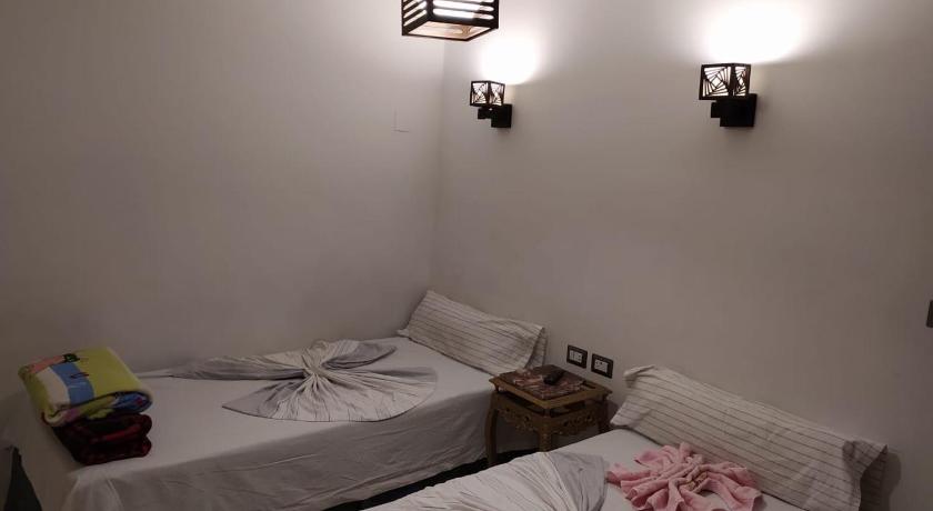 a room with a bed, a table, and a lamp, Venus Hostel in Cairo