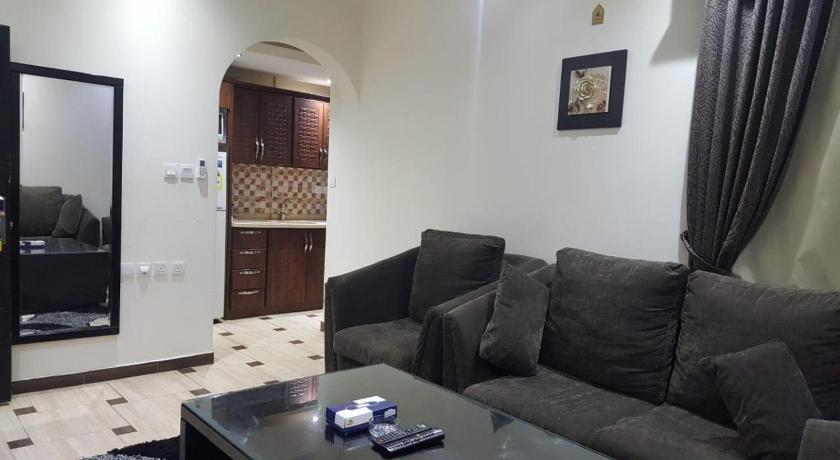 a living room filled with furniture and a tv, Dorar Darea Hotel Apartments - Al Malqa in Riyadh