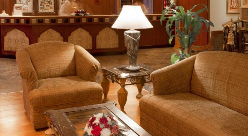 a living room filled with furniture and a fireplace, Landmark Plaza Hotel in Dubai