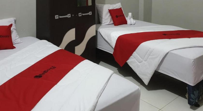a hotel room with two beds and two nightstands, RedDoorz @ Hotel Yaki Mamuju in Mamuju