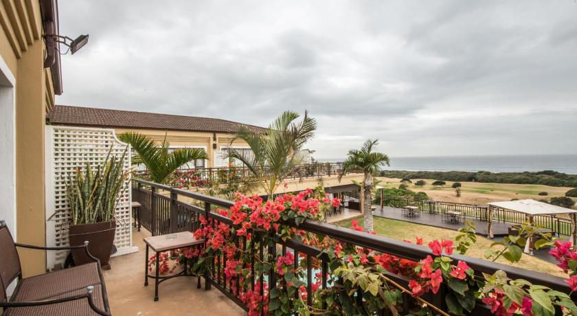 a patio area with a balcony overlooking the ocean, Fairway Guest House in Durban