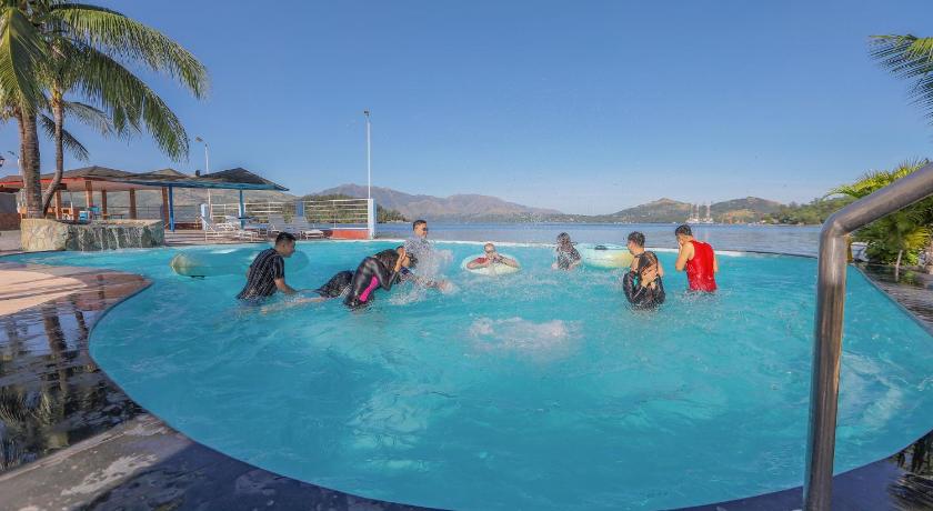 people in a swimming pool with surfboards, White Rock Waterpark and Beach Hotel in Subic (Zambales)