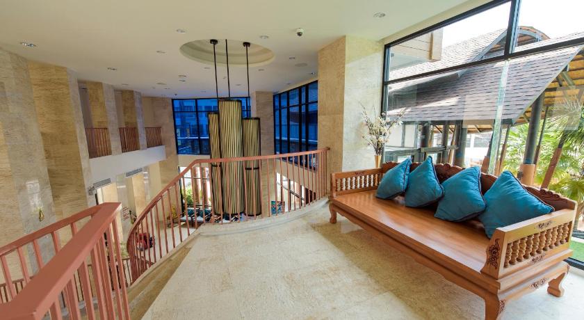 a living room filled with furniture and a balcony, The Lunar Patong Hotel in Phuket