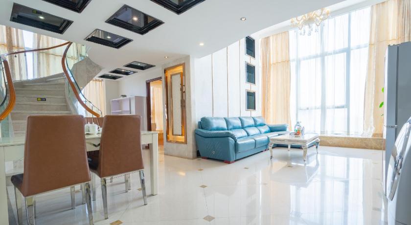 a living room filled with furniture and a large window, Guangzhou Hakka Apartment Beijing Road in Guangzhou