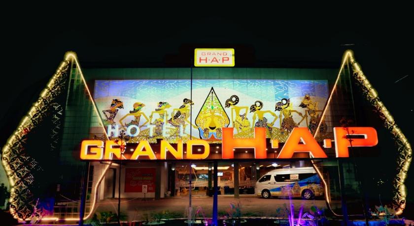 a neon sign on the side of a building, Grand HAP Hotel in Surakarta