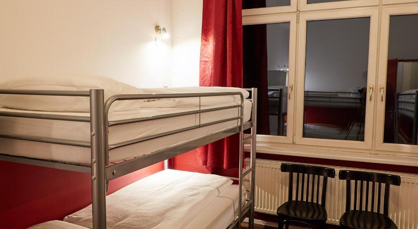 a bedroom with a bed and a window, Ballhaus Berlin Hostel in Berlin