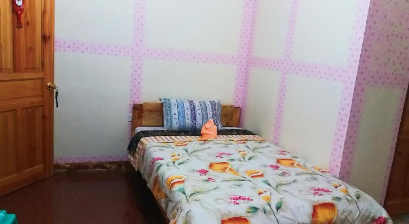 a bedroom with a bed and a window, Semi-Countryside Lodge at SEE TOO VILLE in Sagada