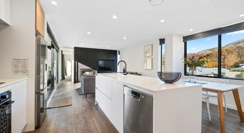 a kitchen with a stove top oven and a sink, Noir South Retreat - Wanaka Holiday Home in Wanaka
