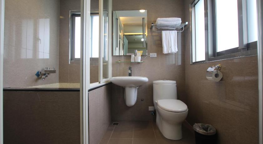 a bathroom with a toilet a sink and a mirror, Pine Villa in Yilan