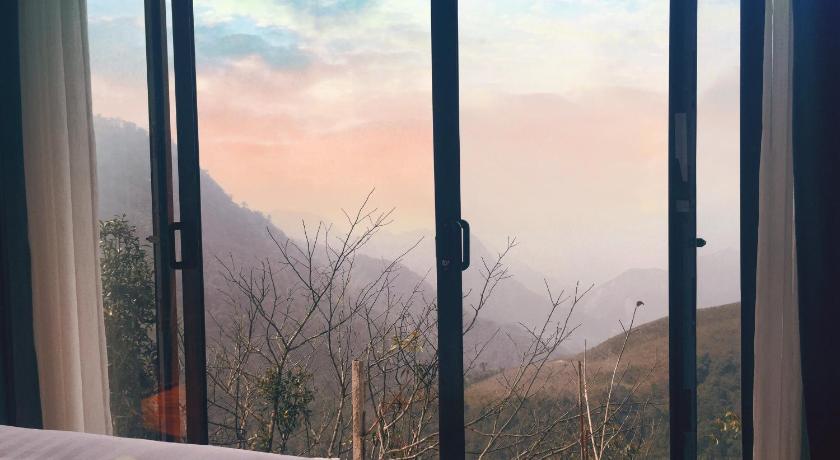 a view through a window of a mountain range, Heaven Gate Hotel O Quy Ho in Sapa