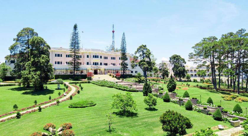 a large building with a large clock on it, Dalat Palace Heritage Hotel in Dalat