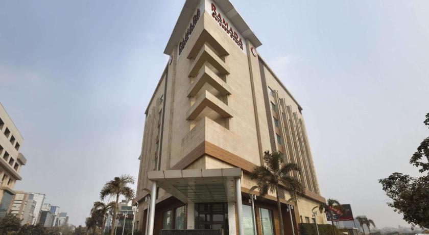 a tall building with a clock on the front of it, Ramada by Wyndham Gurgaon Central in New Delhi and NCR