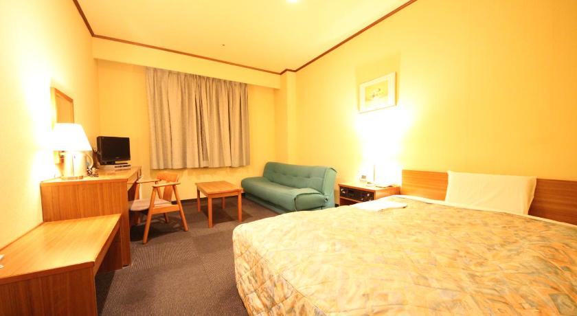 a hotel room with two beds and a television, New Gifu Hotel Plaza in Gifu