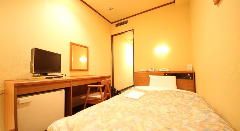 a hotel room with a bed and a television, New Gifu Hotel Plaza in Gifu