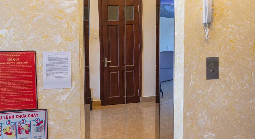 a door is open to a room with a blue door, Huyen 179 Hotel in Dalat