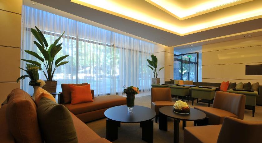 a living room filled with furniture and a large window, Zenda Suites in Tainan