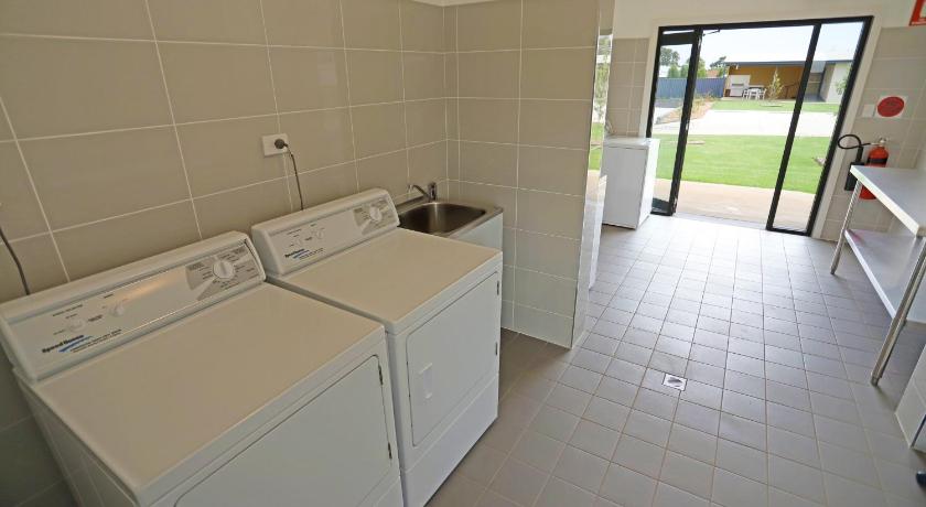 a bathroom with a sink, toilet and tub, Eastend Studio Apartments in Dubbo