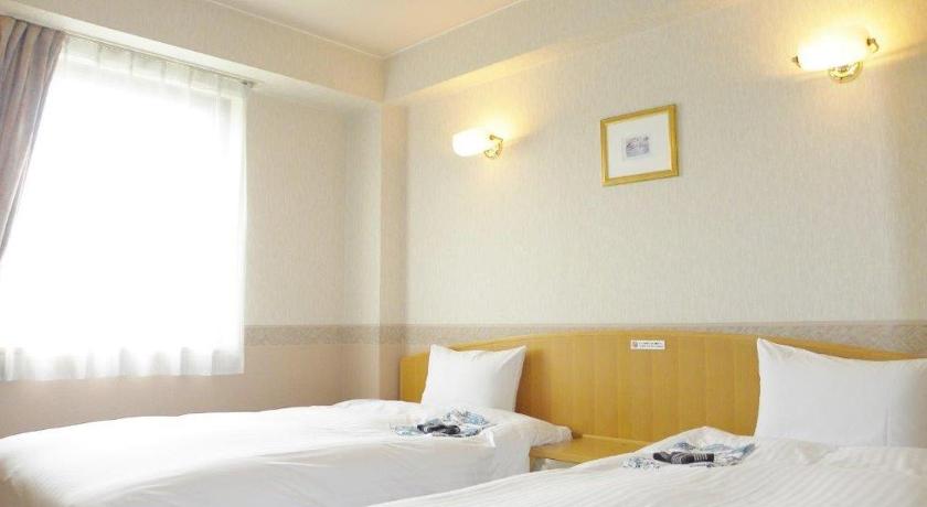 a hotel room with two beds and two lamps, Hotel Benex Yonezawa in Yonezawa