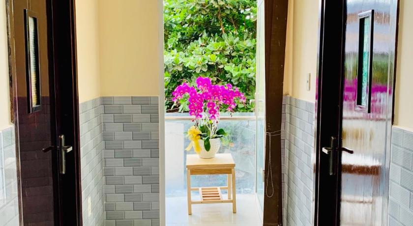 a doorway leading to a room with a table and chairs, Mekong Rose Hotel in Cần Thơ