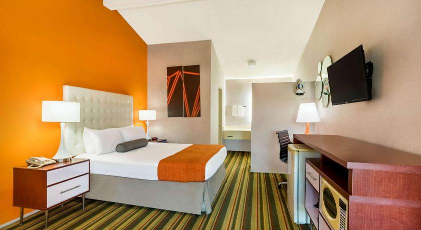 a hotel room with two beds and a television, Howard Johnson by Wyndham Phoenix Airport/Downtown Area in Phoenix (AZ)
