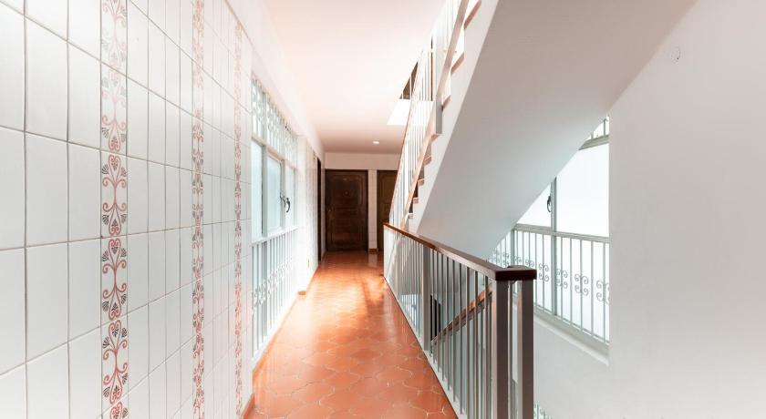 an empty hallway with a large window, Suites Internacional in Guadalajara