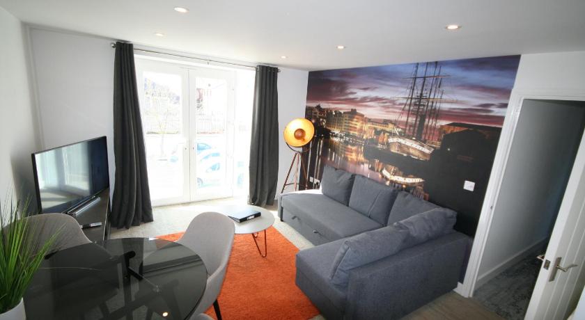 a living room filled with furniture and a tv, Brunel Loft Apartments - YA in Bristol