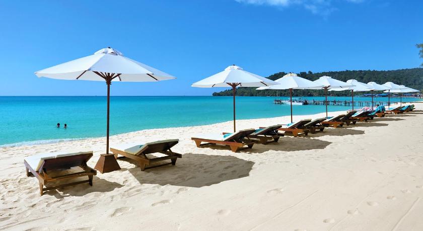 a row of beach chairs and umbrellas on a beach, Sok San Beach Resort in Koh Rong