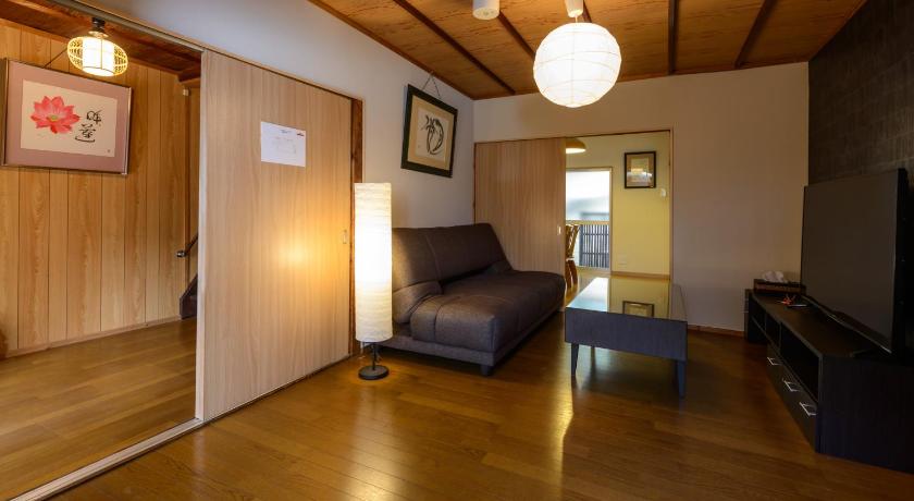 a living room filled with furniture and a tv, Shiki Homes | HIKARI  in Kyoto