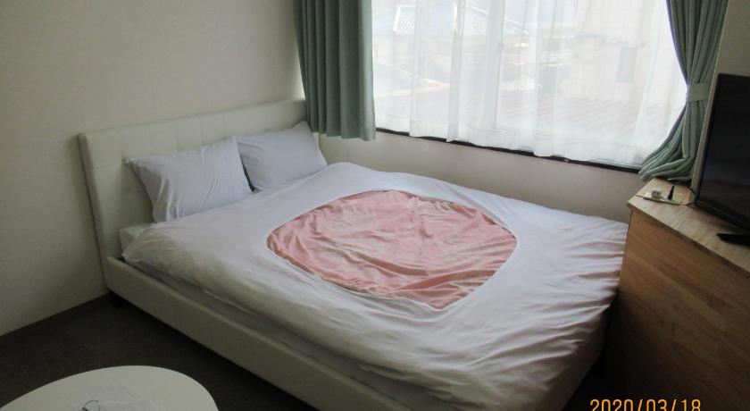 a bed with a white comforter and pillows, Weekly Mansion Ise No.6 in Ise
