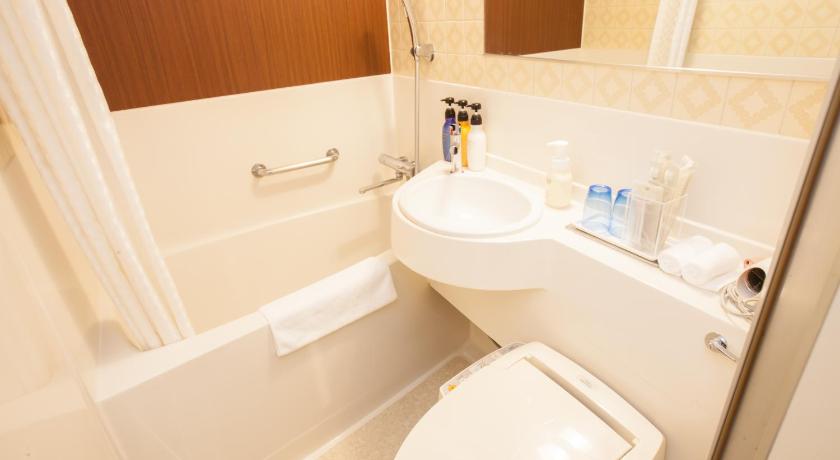 a white toilet sitting next to a sink in a bathroom, the b nagoya in Nagoya