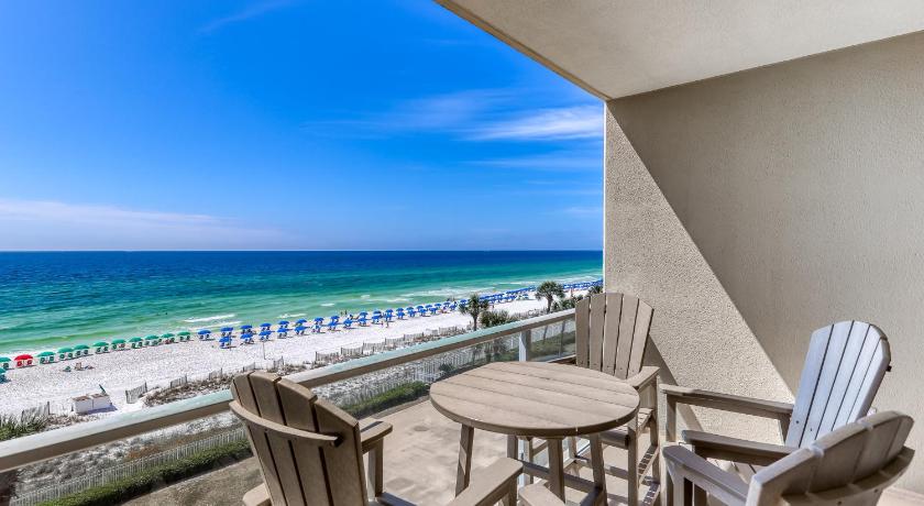a beach area with chairs, tables, and a balcony, Sterling Sands 412 Destin (Condo) in Destin (FL)