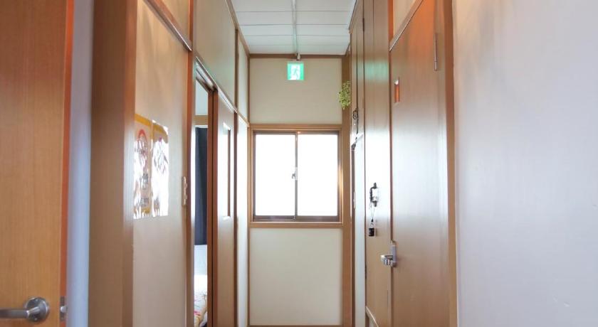 a room with a door open and a light hanging on the wall, Nishiki no Yakata, Asakusa, Skytree, Akihabara in Tokyo