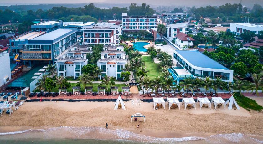 a large group of people sitting on top of a beach, Saint Tropez Beach Resort Hotel in Chanthaburi