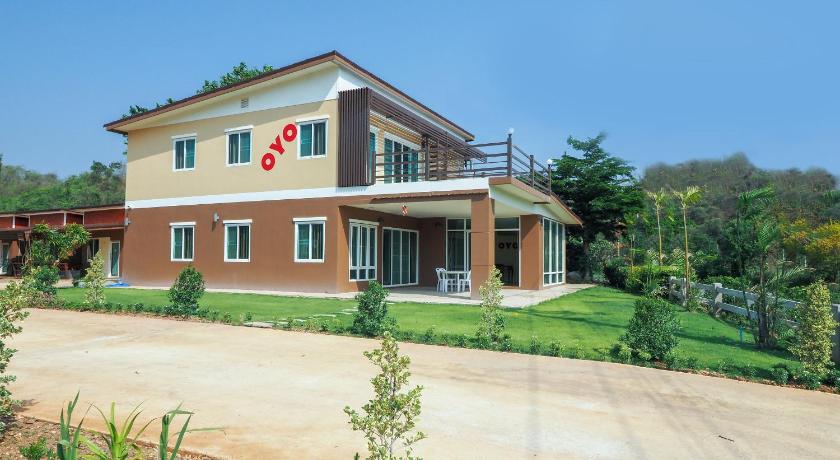 a large brick building with a clock on the front of it, OYO 803 Ai Villa  in Khao Yai