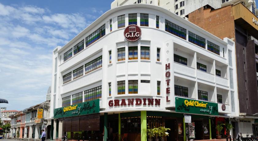 a large building with a large clock on the front of it, Grand Inn Penang Road in Penang