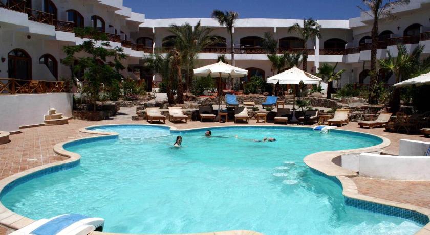 a swimming pool with a pool table and chairs, Planet Oasis Resort Dahab in Dahab