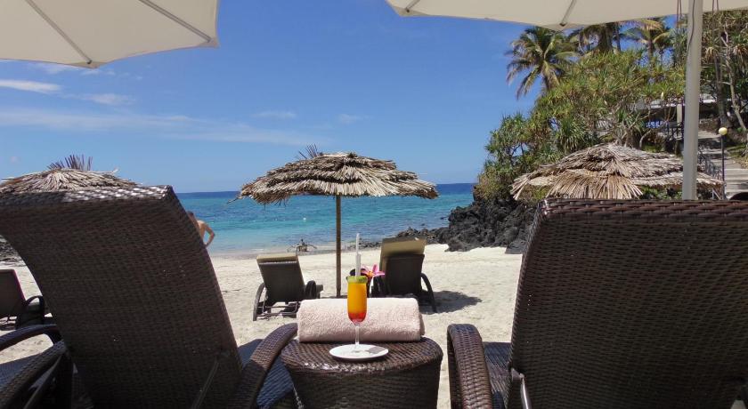 a table with an umbrella and chairs on a beach, Golden Tulip Grande Comore Moroni Resort & Spa in Moroni