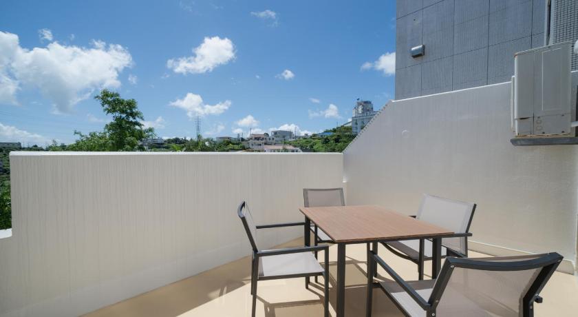 a patio area with a table and chairs, HIYAGUN Lanai Resort Okinawa in Okinawa Main island